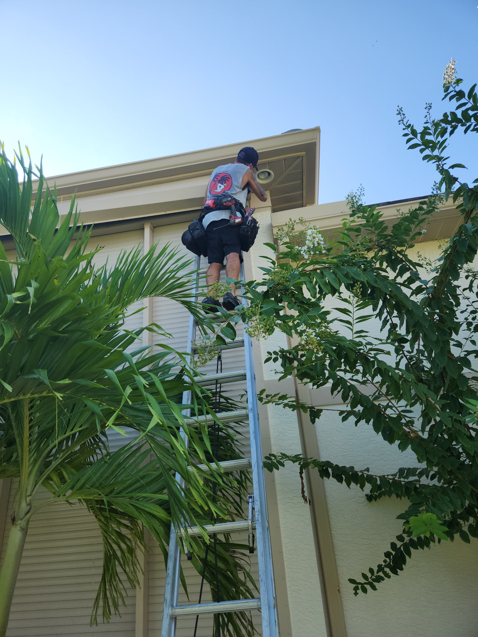 Technician repairing a hurricane shutter on a Fort Myers home